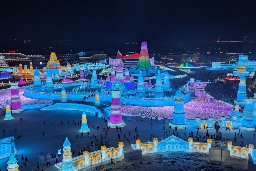 Night view of Harbin Ice and Snow World with glowing ice palaces and colorful lights