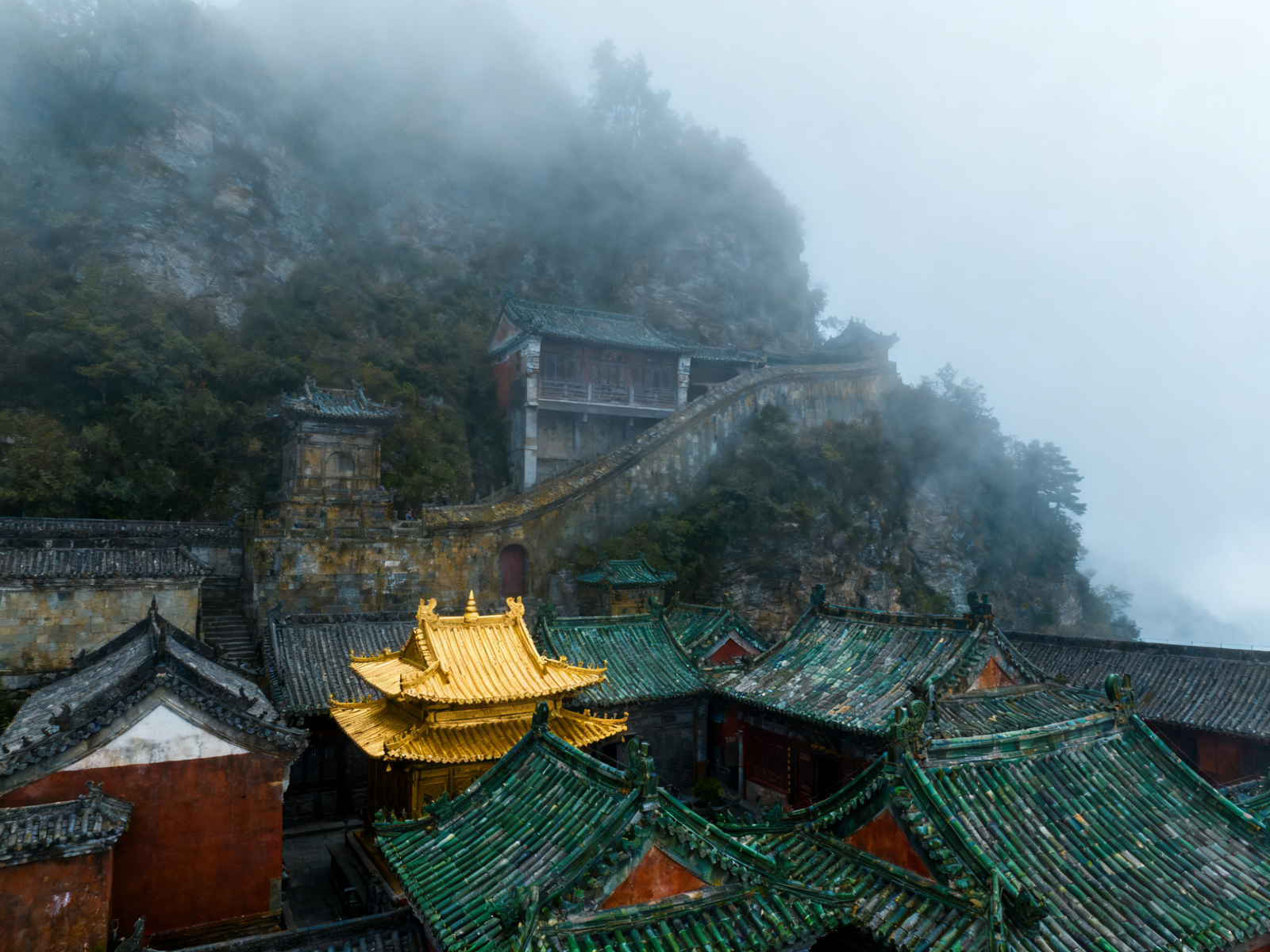 Wudang’s ridge-line palaces and the Golden Summit in morning mist; curved roofs trace Taiji’s arcs.